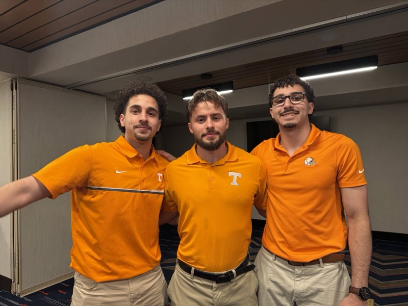 Coaches in matching Tennessee Vols orange polos
