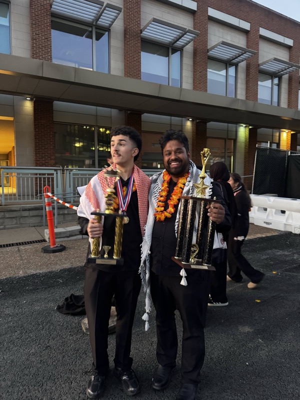 Holding trophies at dusk
