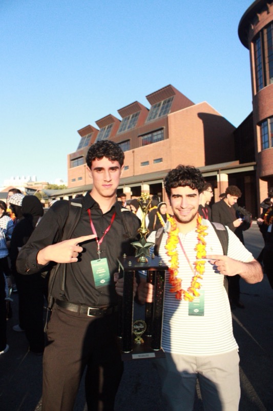 Pointing at trophy at sunset