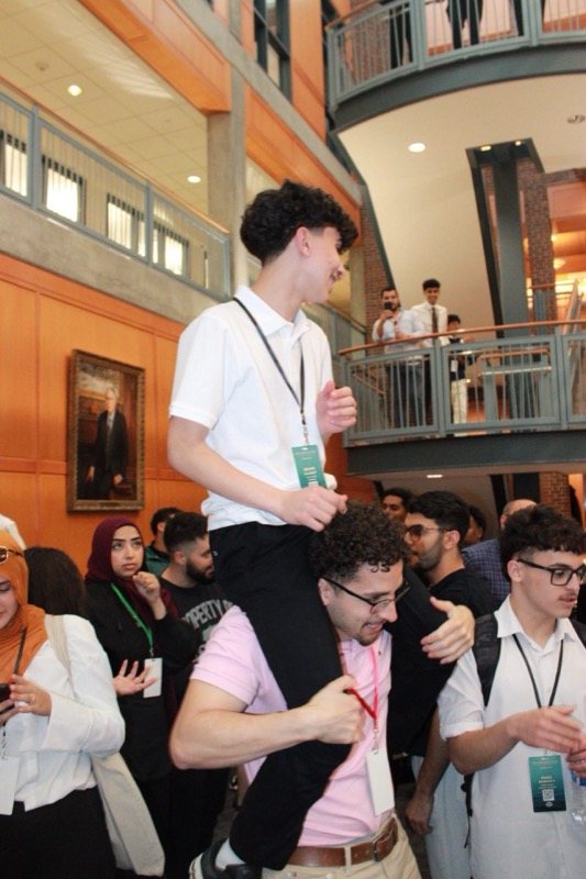 Carried on shoulders in atrium