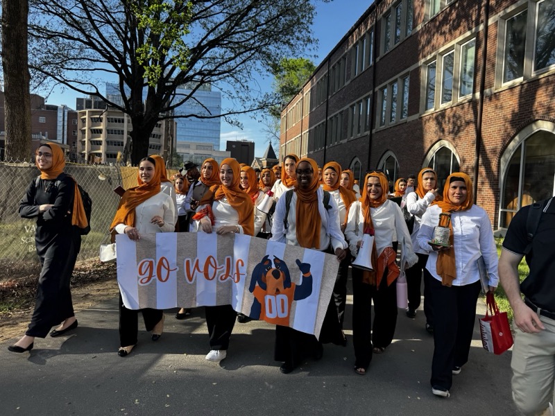 Girls marching with GO VOLS banner